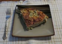 one serving artichoke mushroom crust-less quiche on a plate