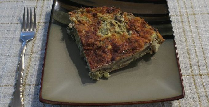 one serving artichoke mushroom crust-less quiche on a plate