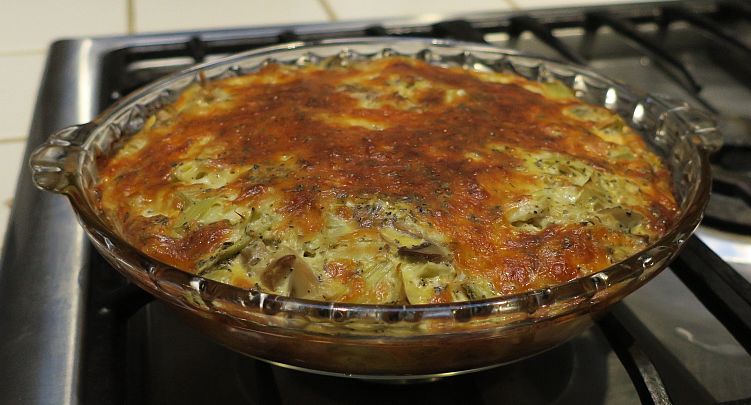 artichoke mushroom crust-less quiche in a glass pie pan