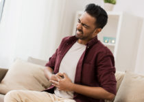 Man seeming to suffer acid reflux and heartburn