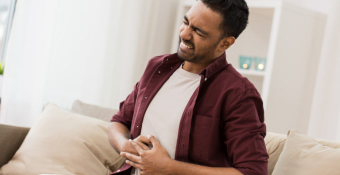 Man seeming to suffer acid reflux and heartburn