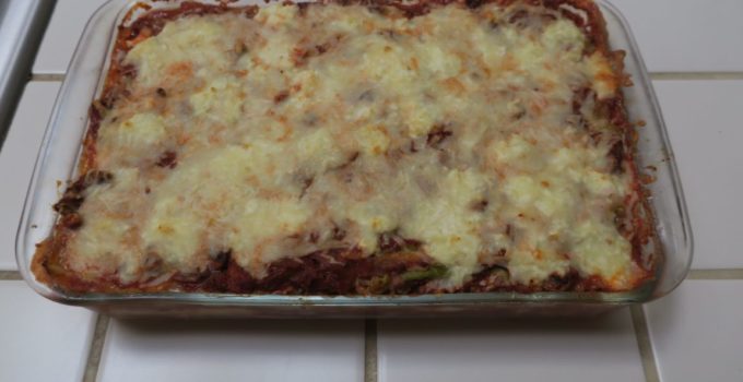 Pan of fresh cooked lasagna on a tile counter