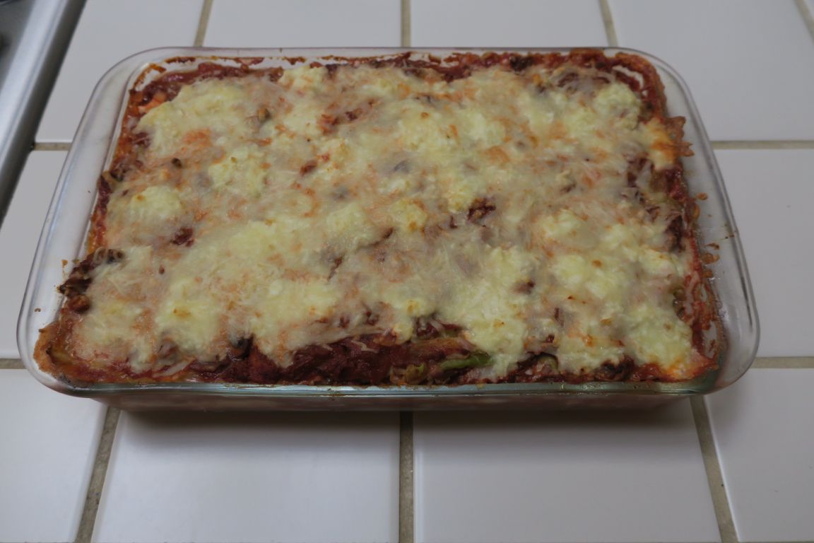 Pan of fresh cooked lasagna on a tile counter