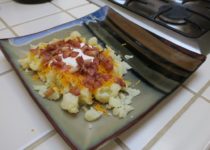 loaded cauliflower is just chopped, cooked cauliflower topped with cheese, bacon, and sour cream