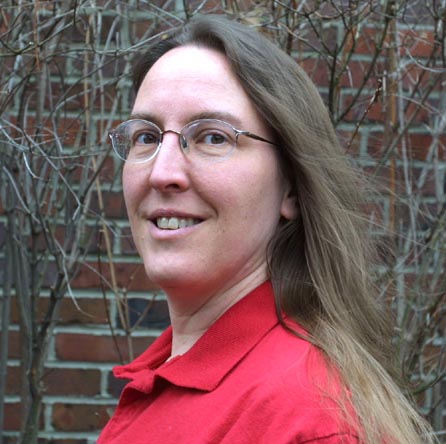 Headshot of Geri in red shirt