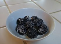 dish of black berries in cream poured over