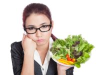 Asian business woman bored with salad bowl