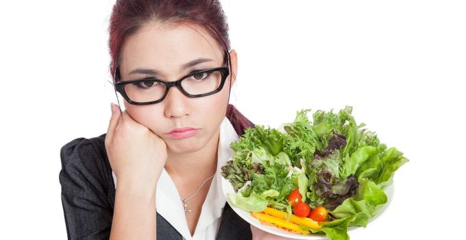 Asian business woman bored with salad bowl