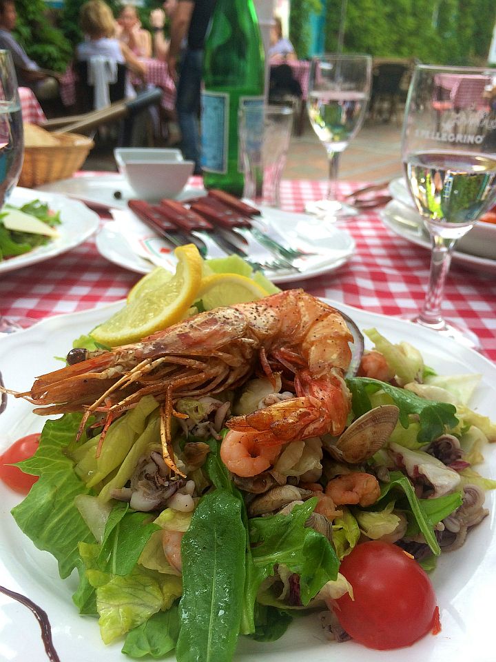 closeup of salad topped with roasted lobster at a cafe