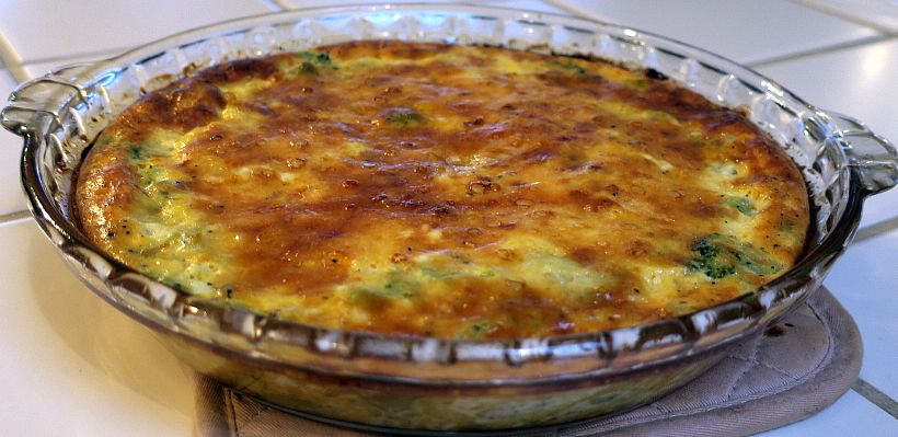 broccoli onion crust-less quiche in a glass pie pan