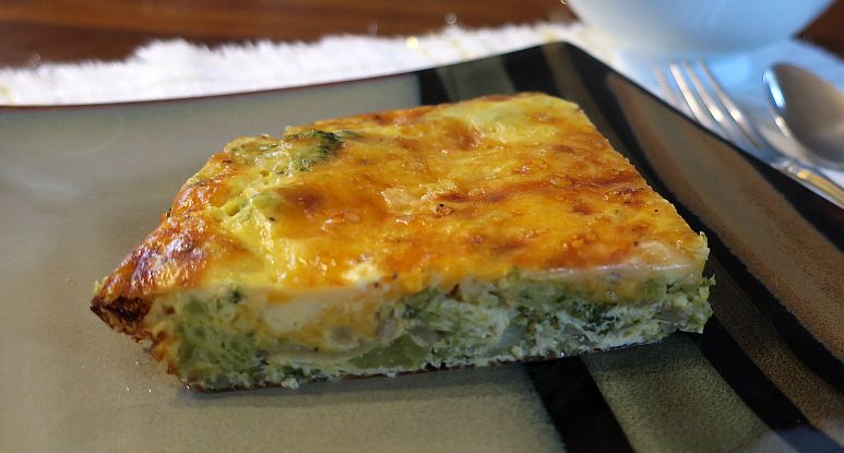 slice of broccoli onion crust-less quiche on a plate