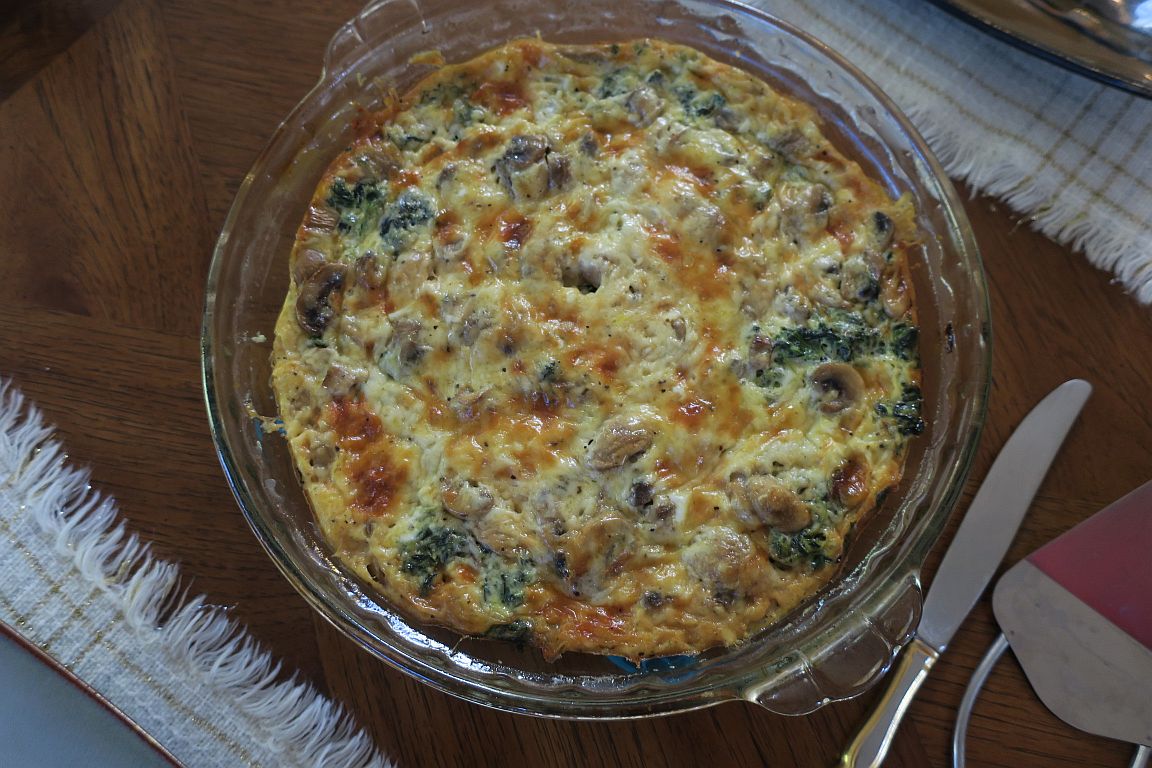 top view spinach mushroom crust-less quiche in pie pan