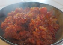 Shirataki Spanish Rice in a dark bowl with steam rising off