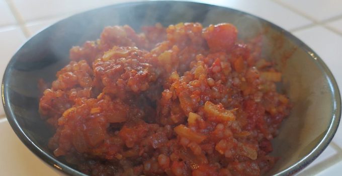 Shirataki Spanish Rice in a dark bowl with steam rising off