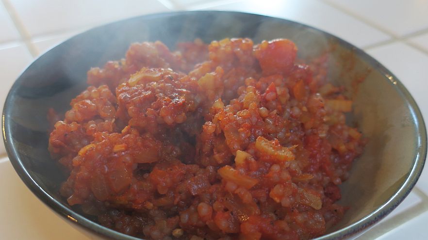 Shirataki Spanish Rice in a dark bowl with steam rising off