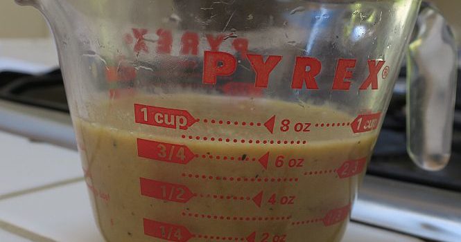 fresh white mushroom gravy in a measuring cup