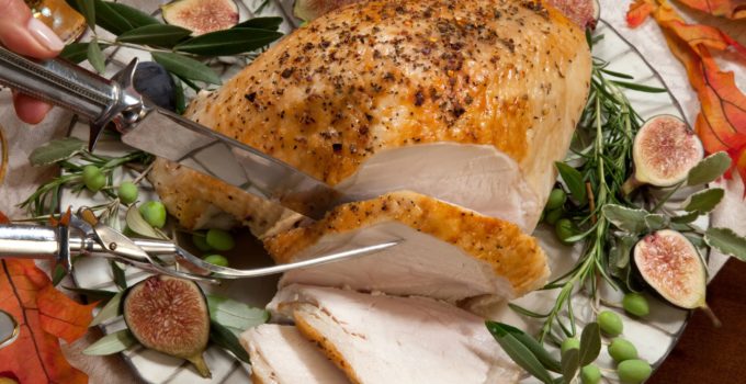 instant pot herbed turkey breast being carved on a plate