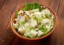classic Waldorf salad with apples, celery, walnuts, and mayo in a brown bow.