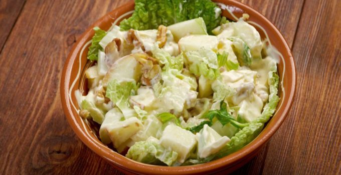 classic Waldorf salad with apples, celery, walnuts, and mayo in a brown bow.