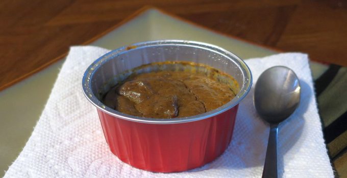 individual gluten-free pumpkin pie custard in a red ramekin on a white napkin