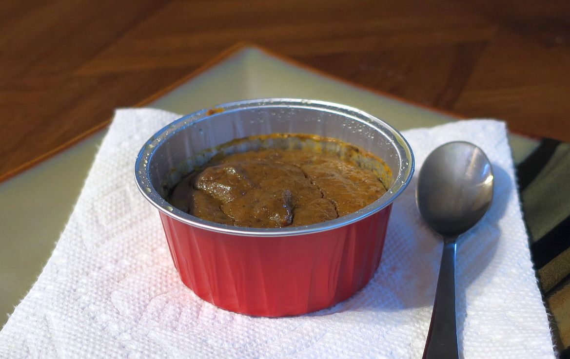 individual gluten-free pumpkin pie custard in a red ramekin on a white napkin